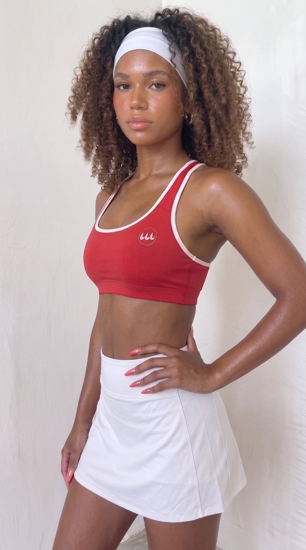 wrapd halter sports bra in red, front view on model