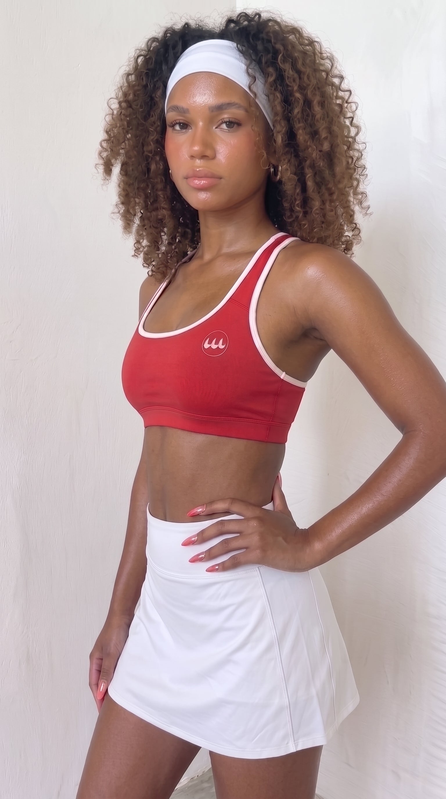 wrapd halter sports bra in red, front view on model