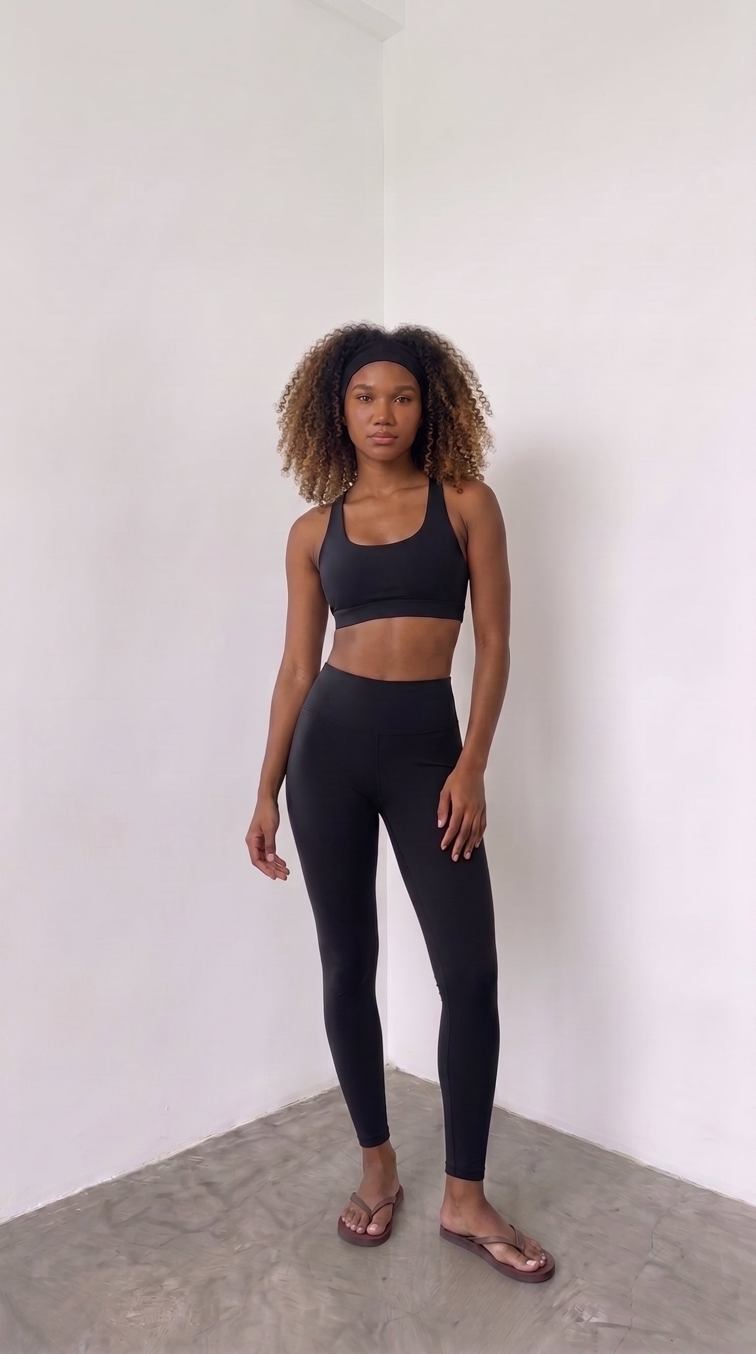 wrapd racerback sports bra in onyx, styled pose on model