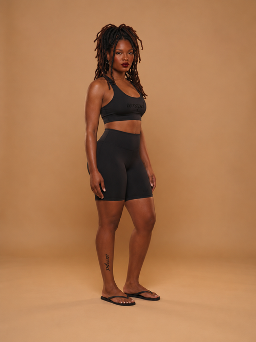 wrapd cropped sports bra in black, front view on model