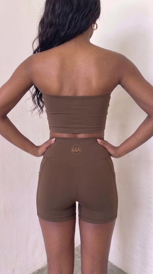 wrapd high-waisted pocket biker short in brown, back view showing logo detail