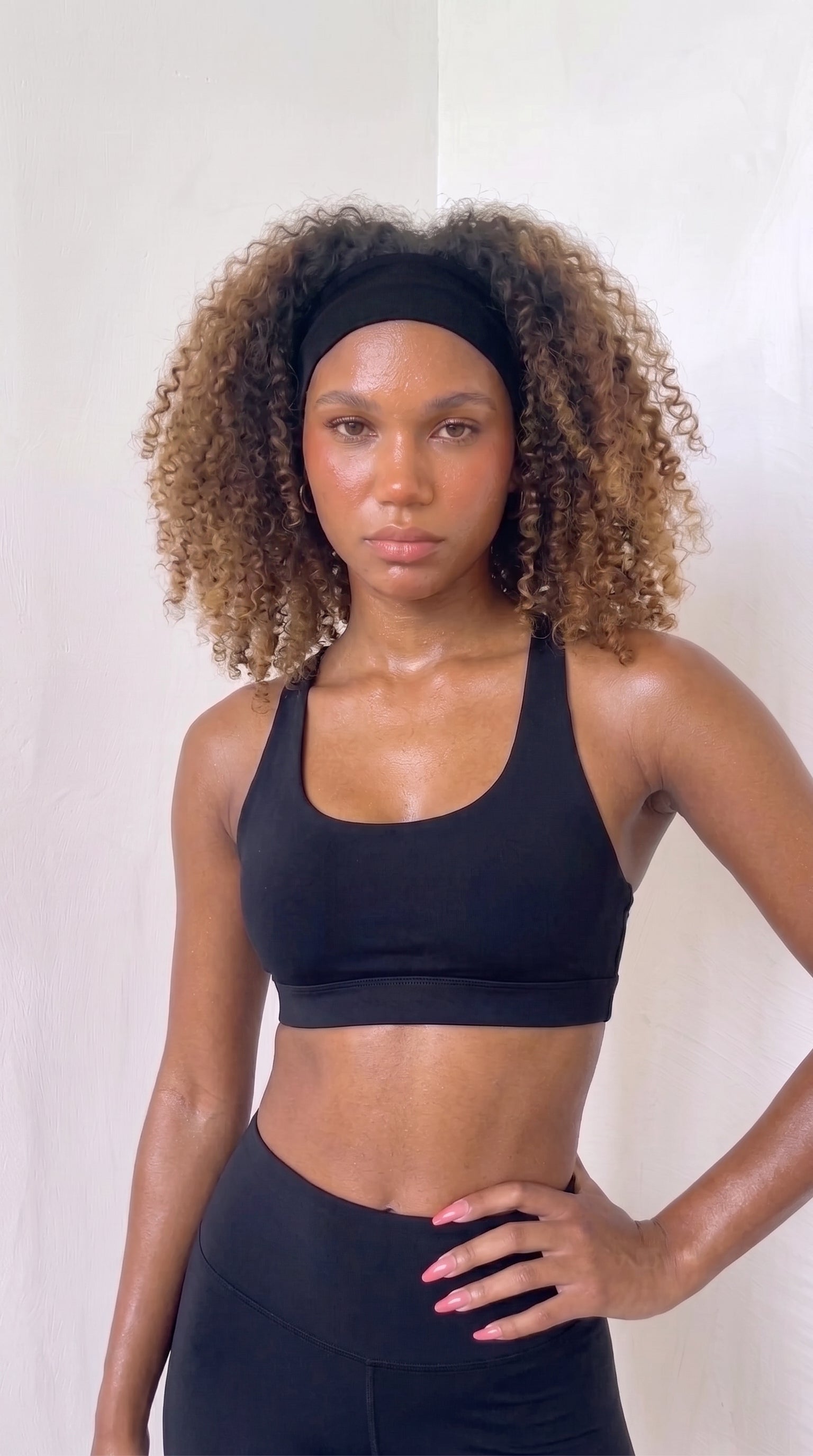 wrapd racerback sports bra in onyx, front view on model