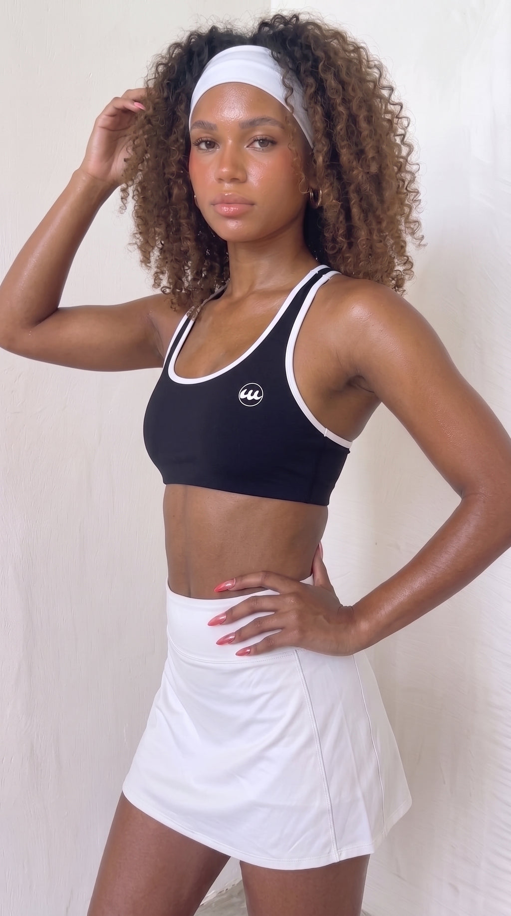 wrapd halter sports bra in black, front view on model