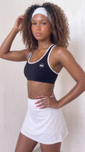 wrapd halter sports bra in black, front view on model