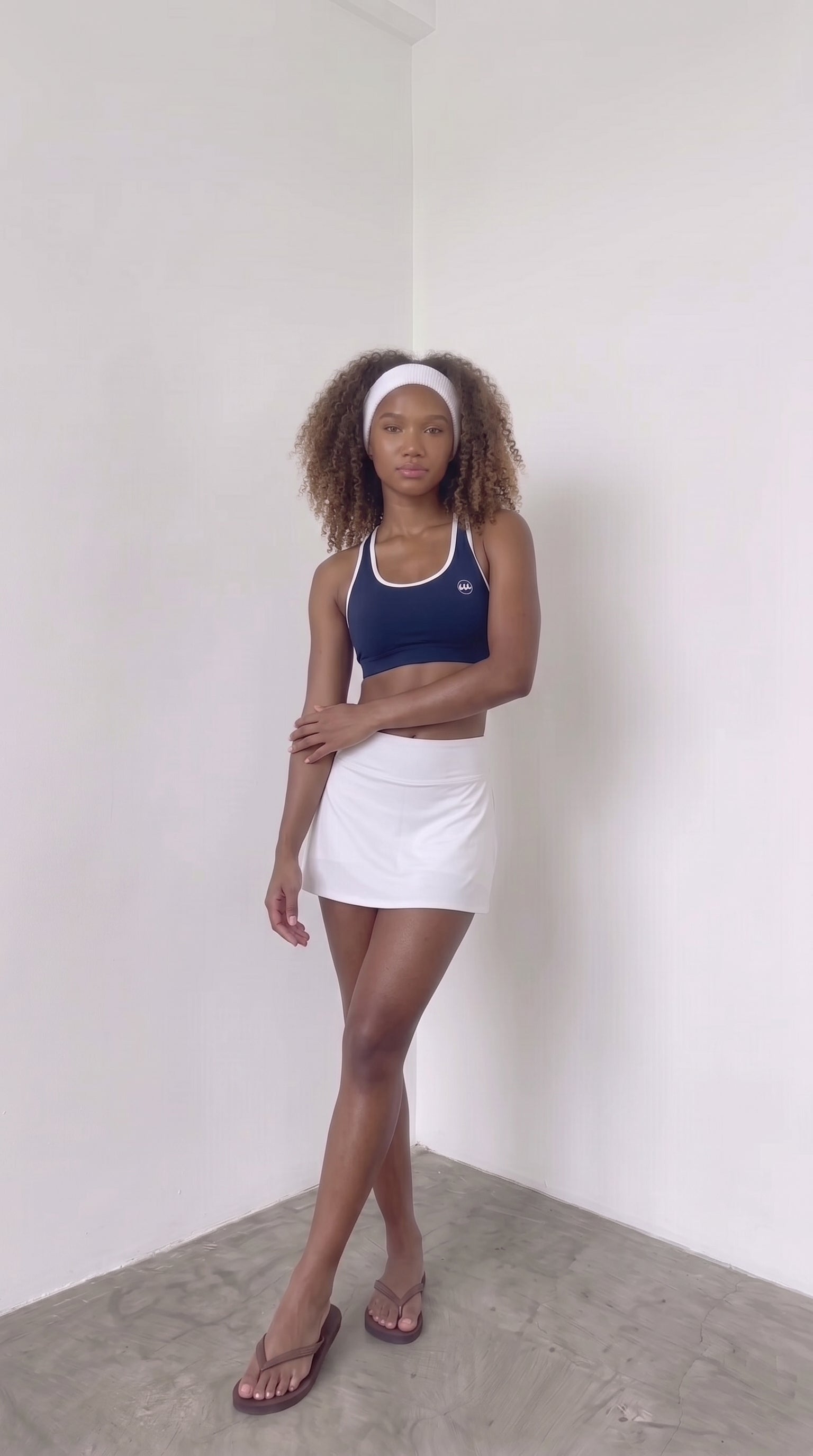 wrapd halter sports bra in navy, styled pose on model