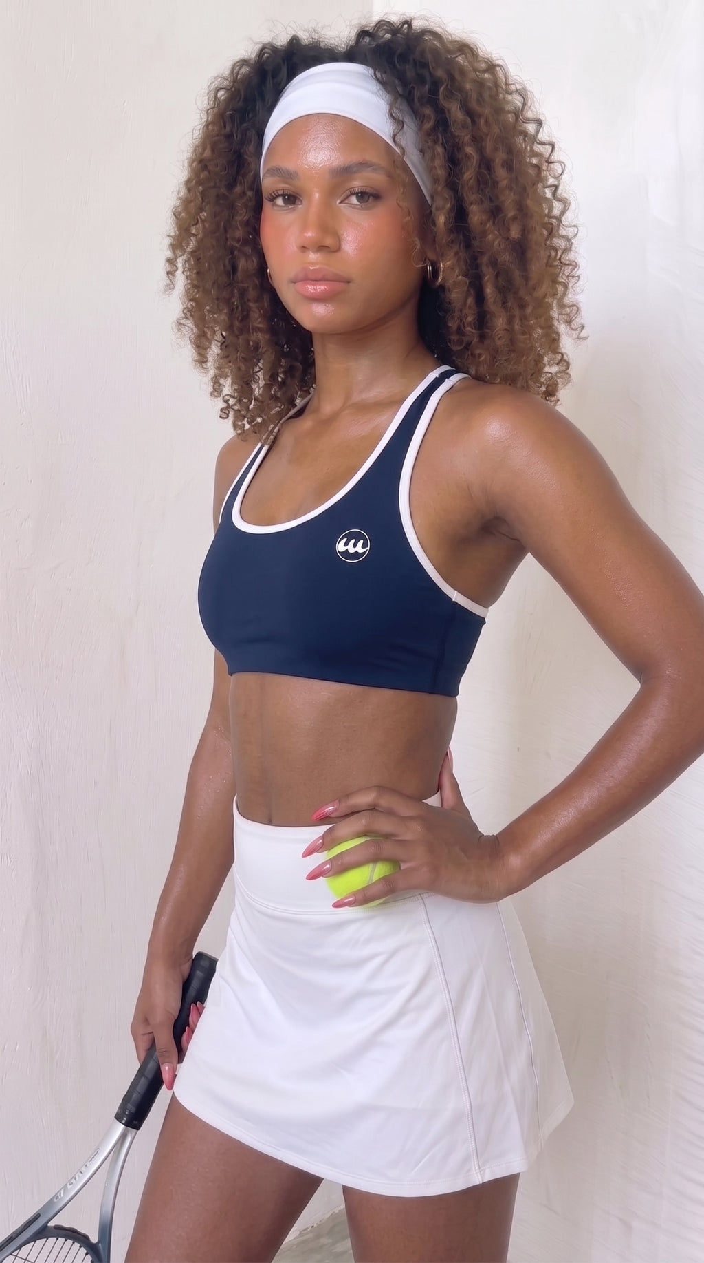 wrapd halter sports bra in navy, front view on model