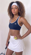 wrapd halter sports bra in navy, front view on model