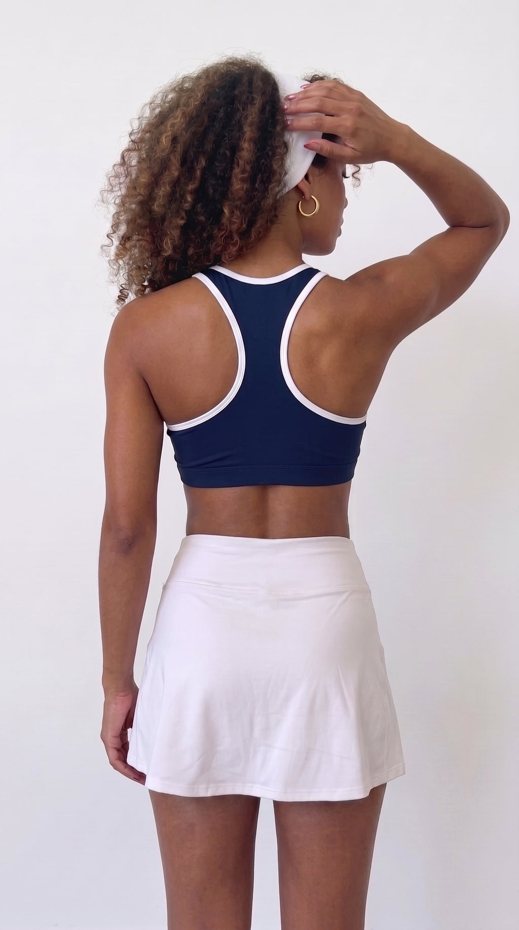 wrapd halter sports bra in navy, side view on model
