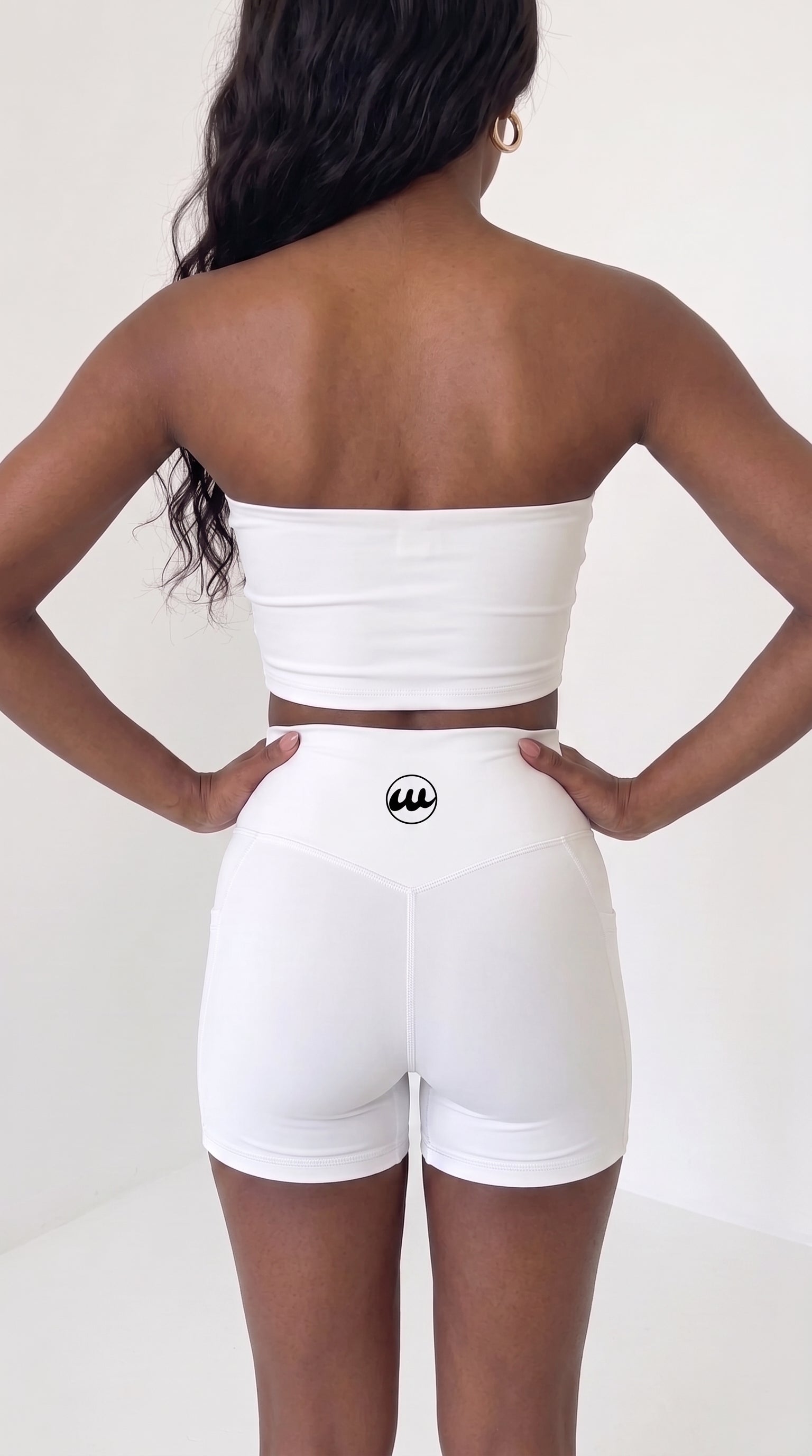 wrapd high-waisted pocket biker short in white, back view on model