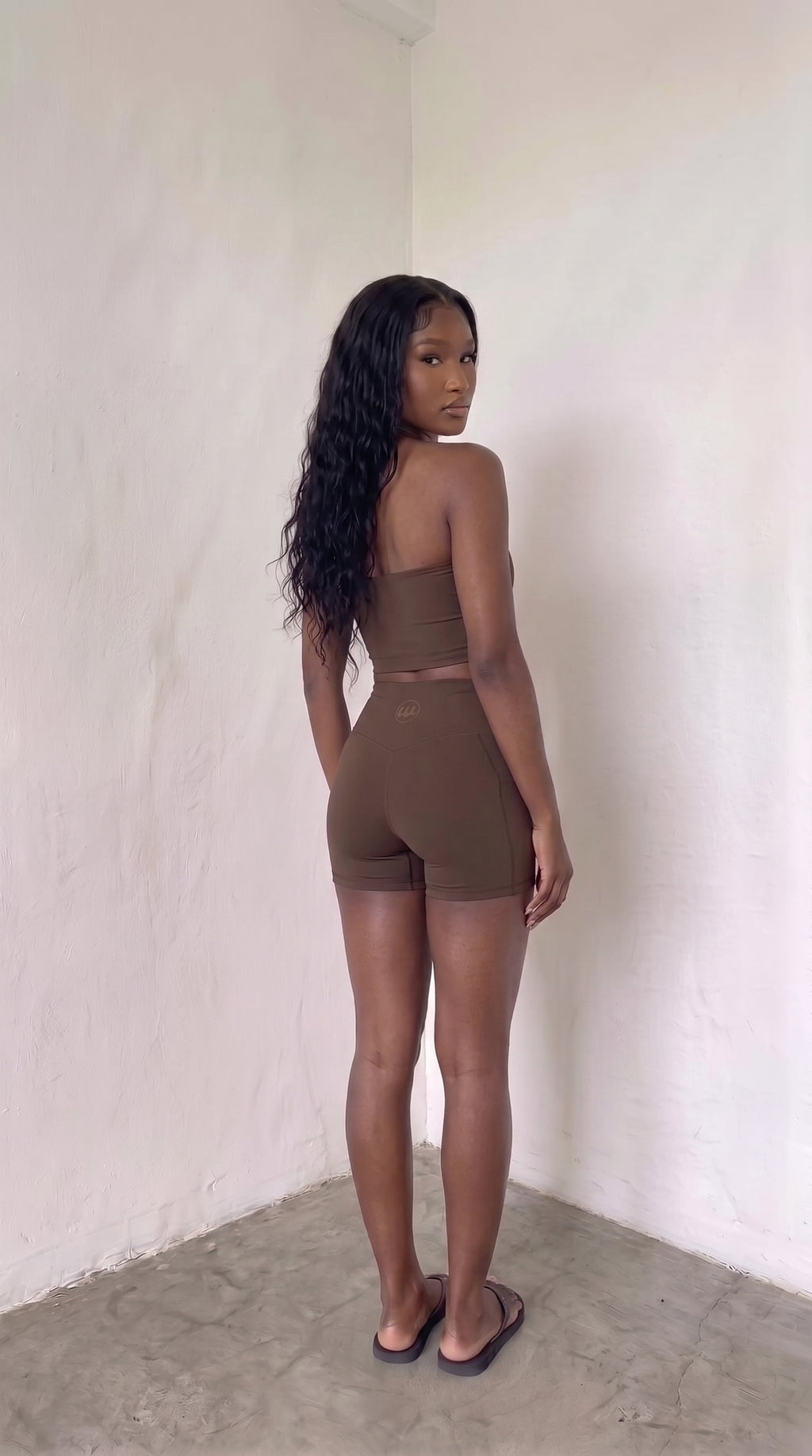wrapd high-waisted pocket biker short in brown, side view showing high-rise waistband and pocket