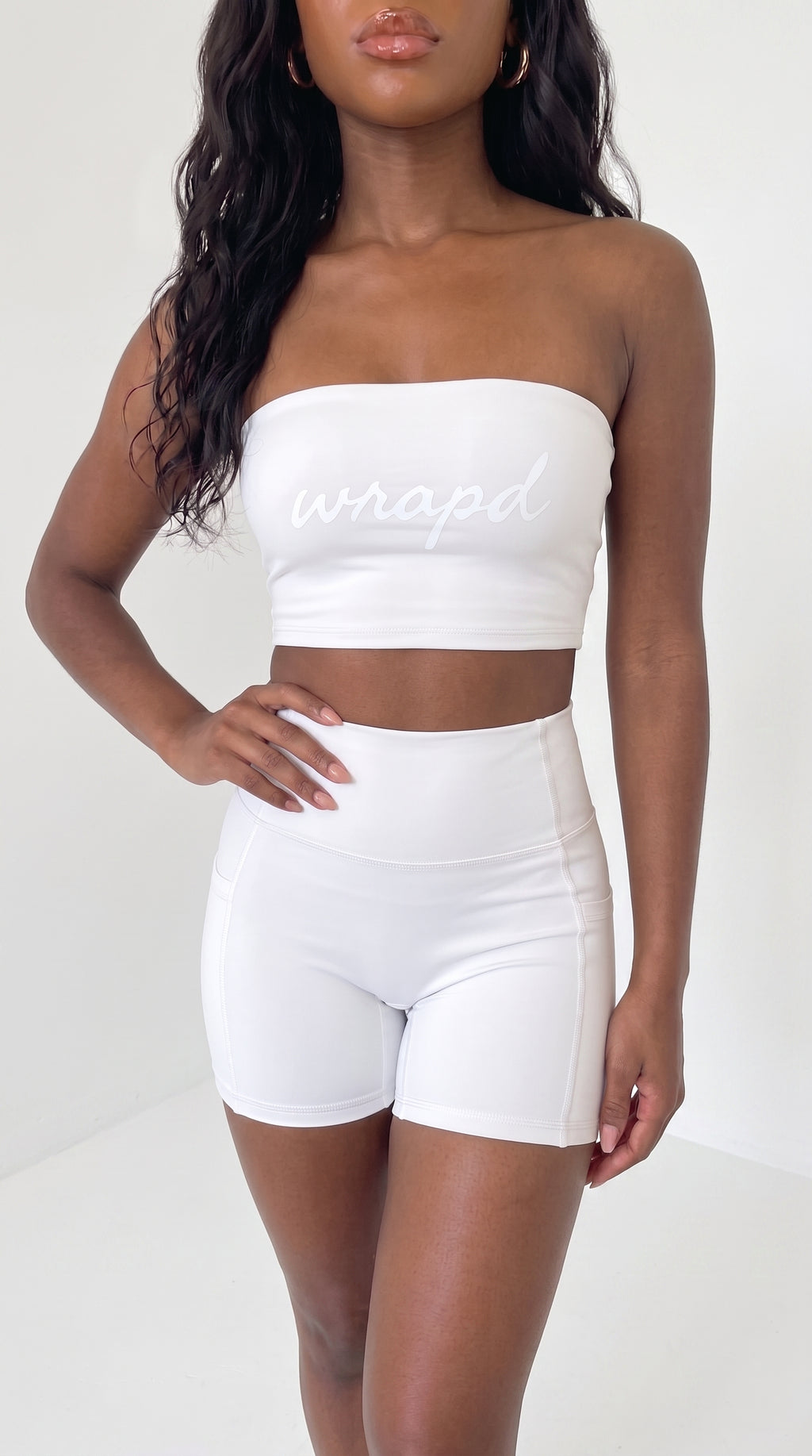 wrapd high-waisted pocket biker short in white, front view on model