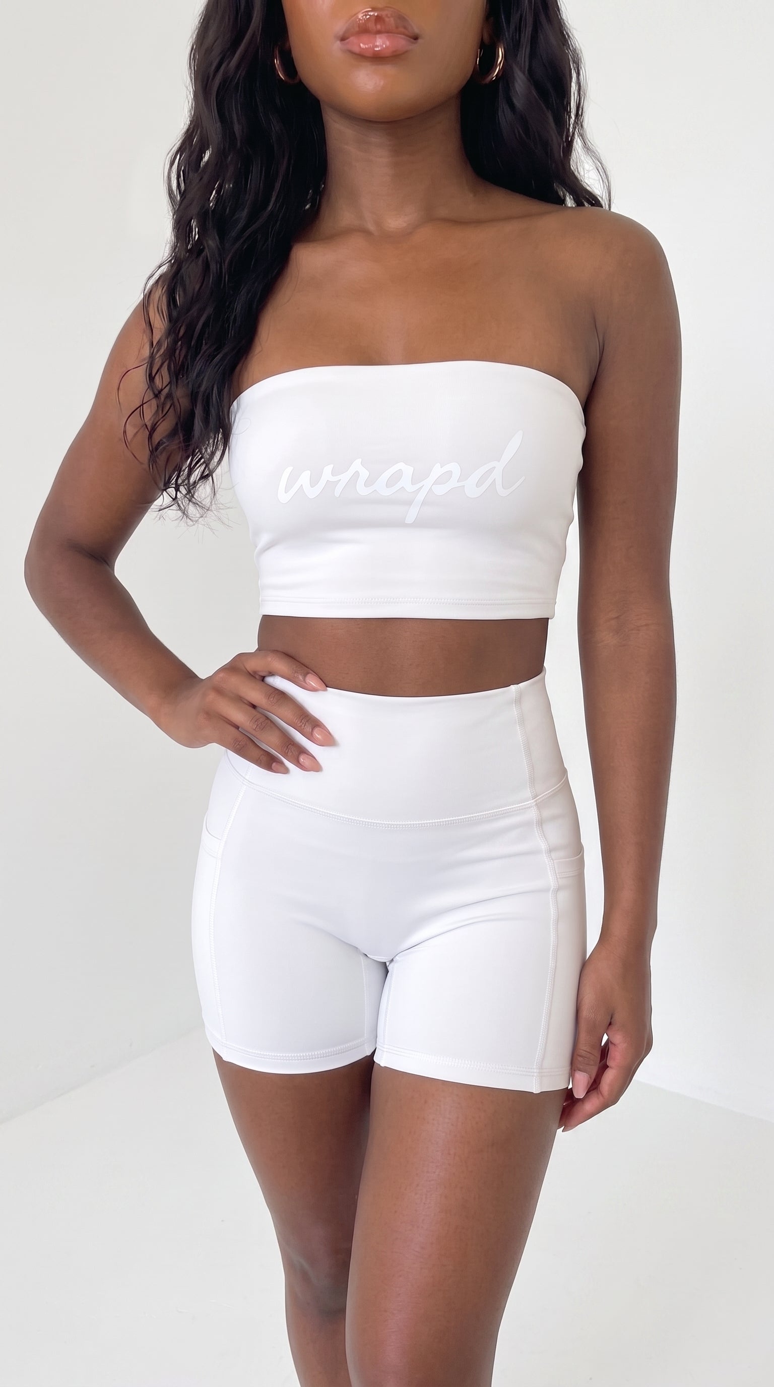 wrapd high-waisted pocket biker short in white, front view on model