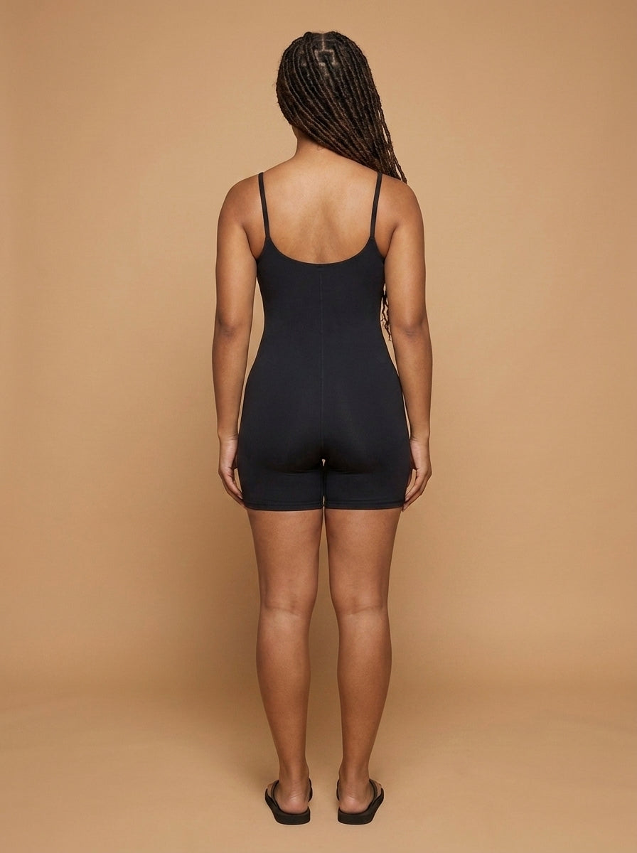 wrapd u-neck yoga romper in black, side view on model