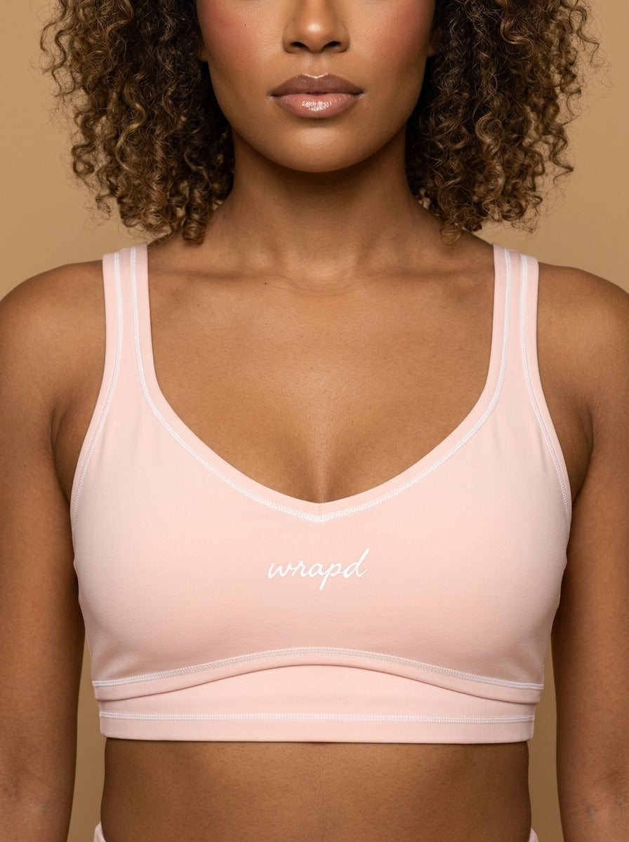 wrapd topstitching sports bra in pink, front view on model