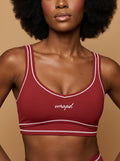 wrapd topstitching sports bra in red, front view on model
