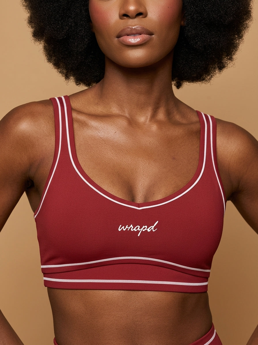 wrapd topstitching sports bra in red, front view on model