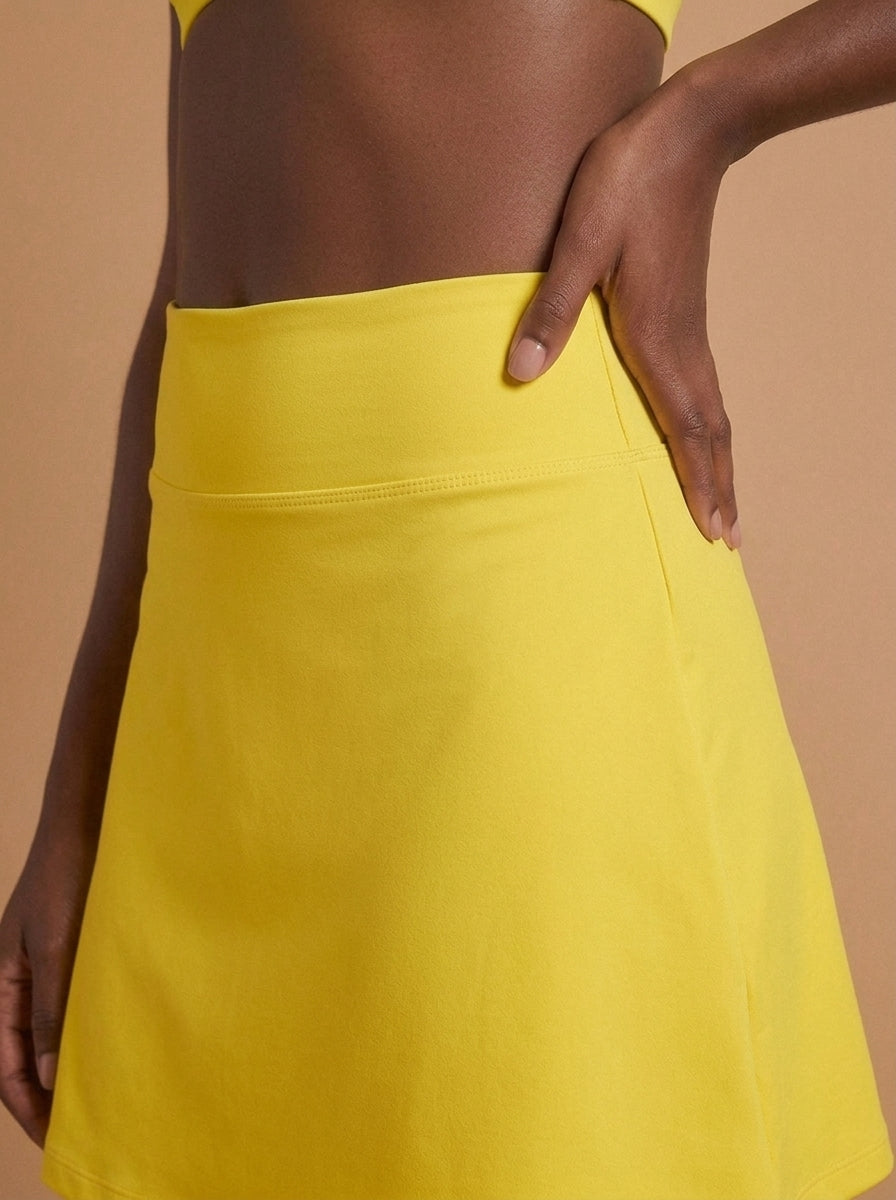 wrapd high-rise a-line skirt in yellow, side view on model